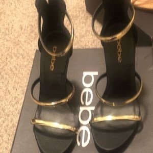 Bebe black and gold heels, never worn; size 7
